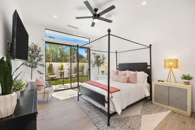 a bedroom with a bed and a flat tv screen