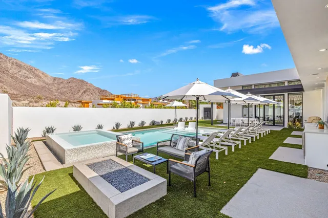 a view of a chairs and table in patio with a lake view