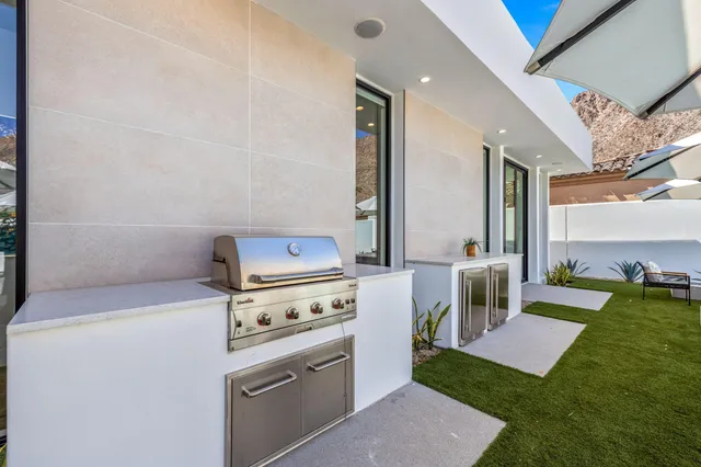 a kitchen with a stove and a view of living room