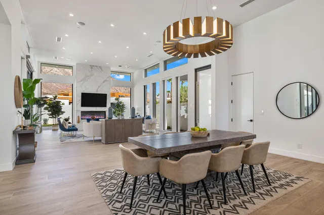 a view of a dining room with furniture and a chandelier