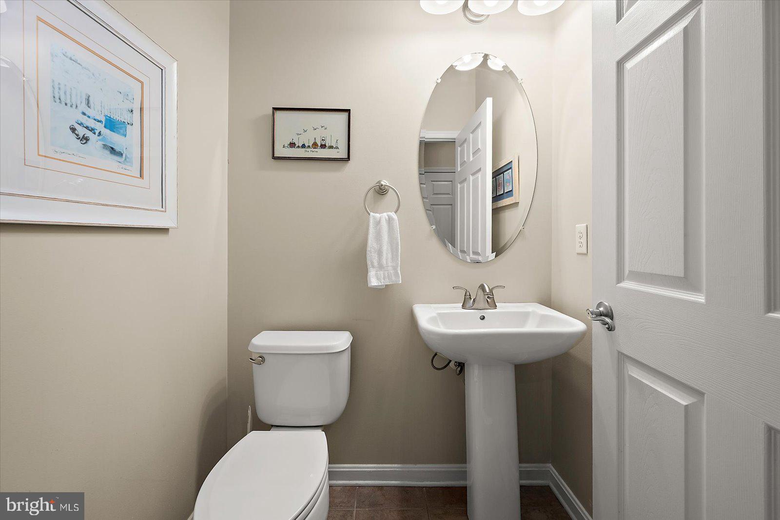 11446 West Sand Cove Road Selbyville, DE 19975 - Photo 29 of 104 a bathroom with a toilet a sink and a mirror
