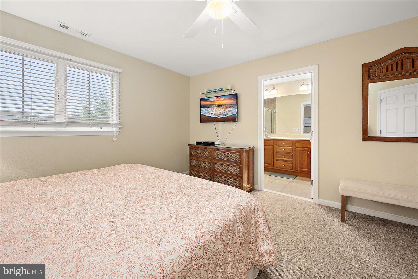 11446 West Sand Cove Road Selbyville, DE 19975 - Photo 31 of 104 a spacious bedroom with a bed and a cabinets