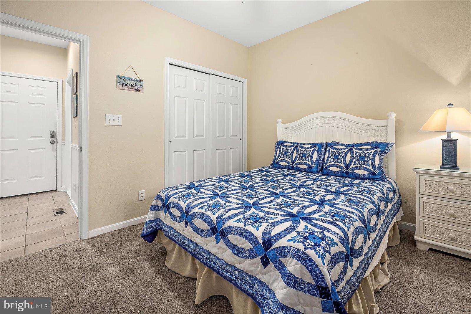 11446 West Sand Cove Road Selbyville, DE 19975 - Photo 37 of 104 a bedroom with a bed and a lamp