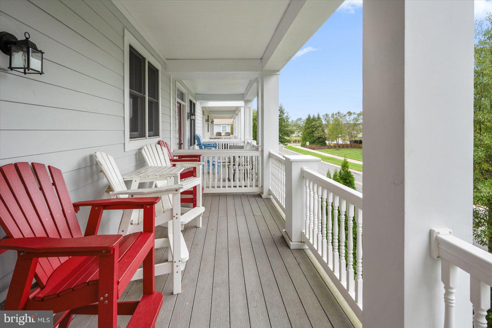 11446 West Sand Cove Road Selbyville, DE 19975 - Photo 52 of 104 a balcony with wooden floor table and chairs
