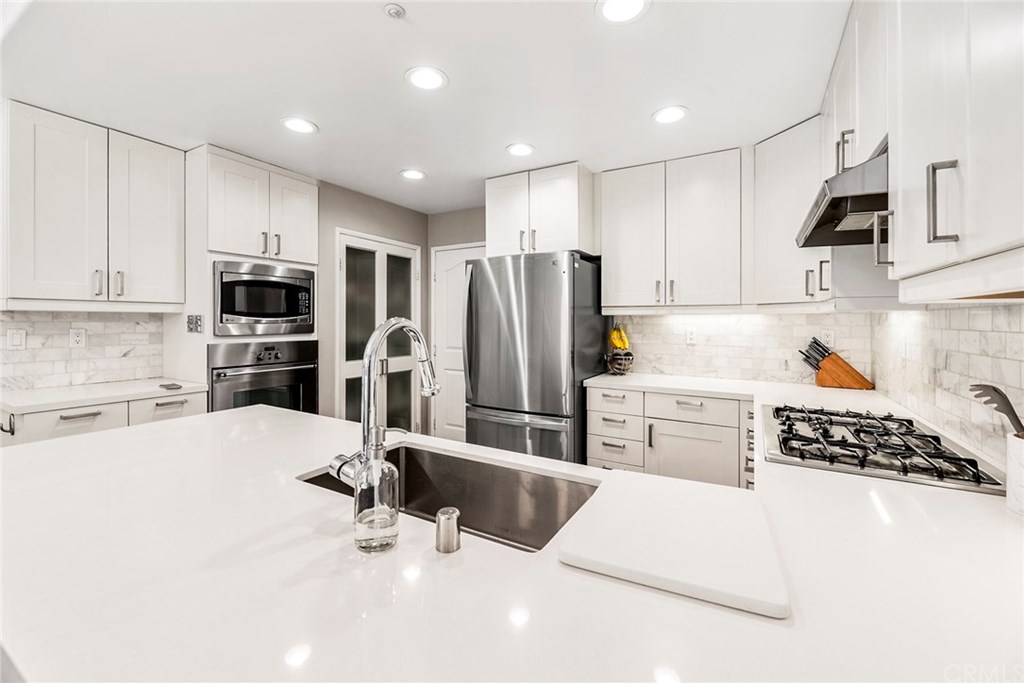 Newly remodeled kitchen with stylish custom design. Corner swivel cabinets and pullouts. Pantry. Recessed lighting. Dishwasher and refrigerator are less than one year old.