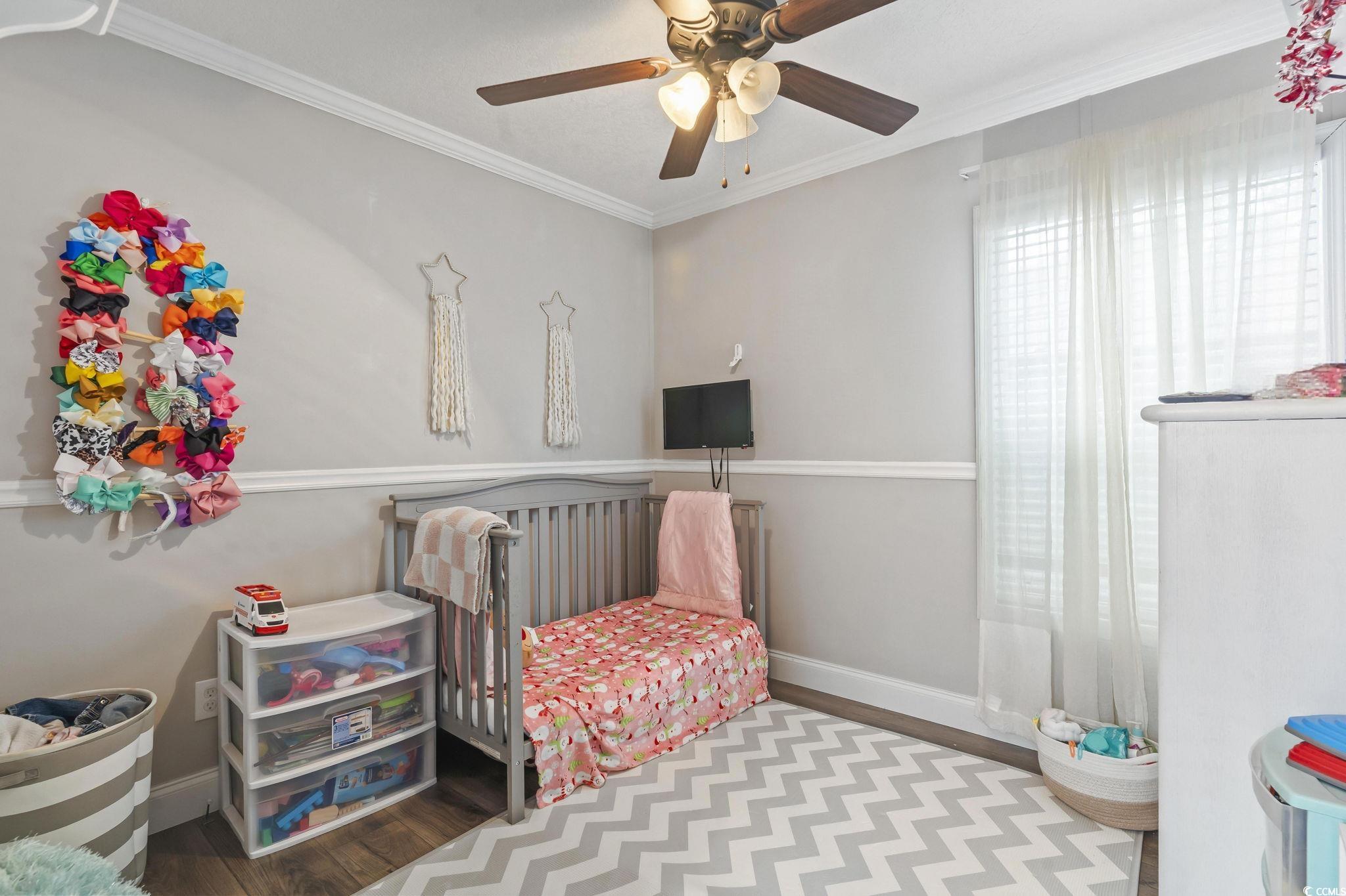 91 Offshore Drive Murrells Inlet, SC 29576 - Photo 18 of 24 Bedroom with wood finished floors, ornamental molding, and a ceiling fan