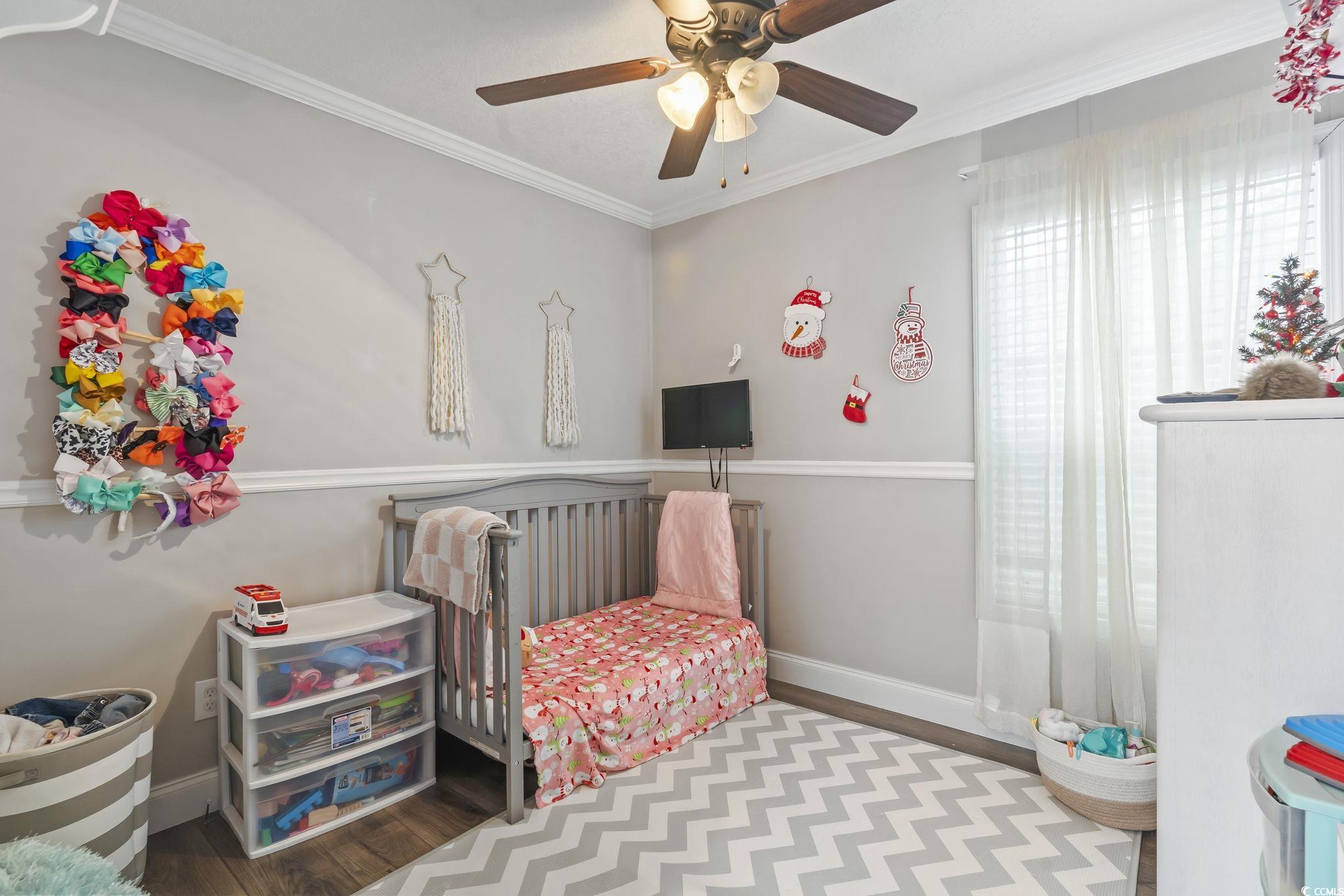 91 Offshore Drive Murrells Inlet, SC 29576 - Photo 19 of 24 Bedroom with wood finished floors, crown molding, and ceiling fan