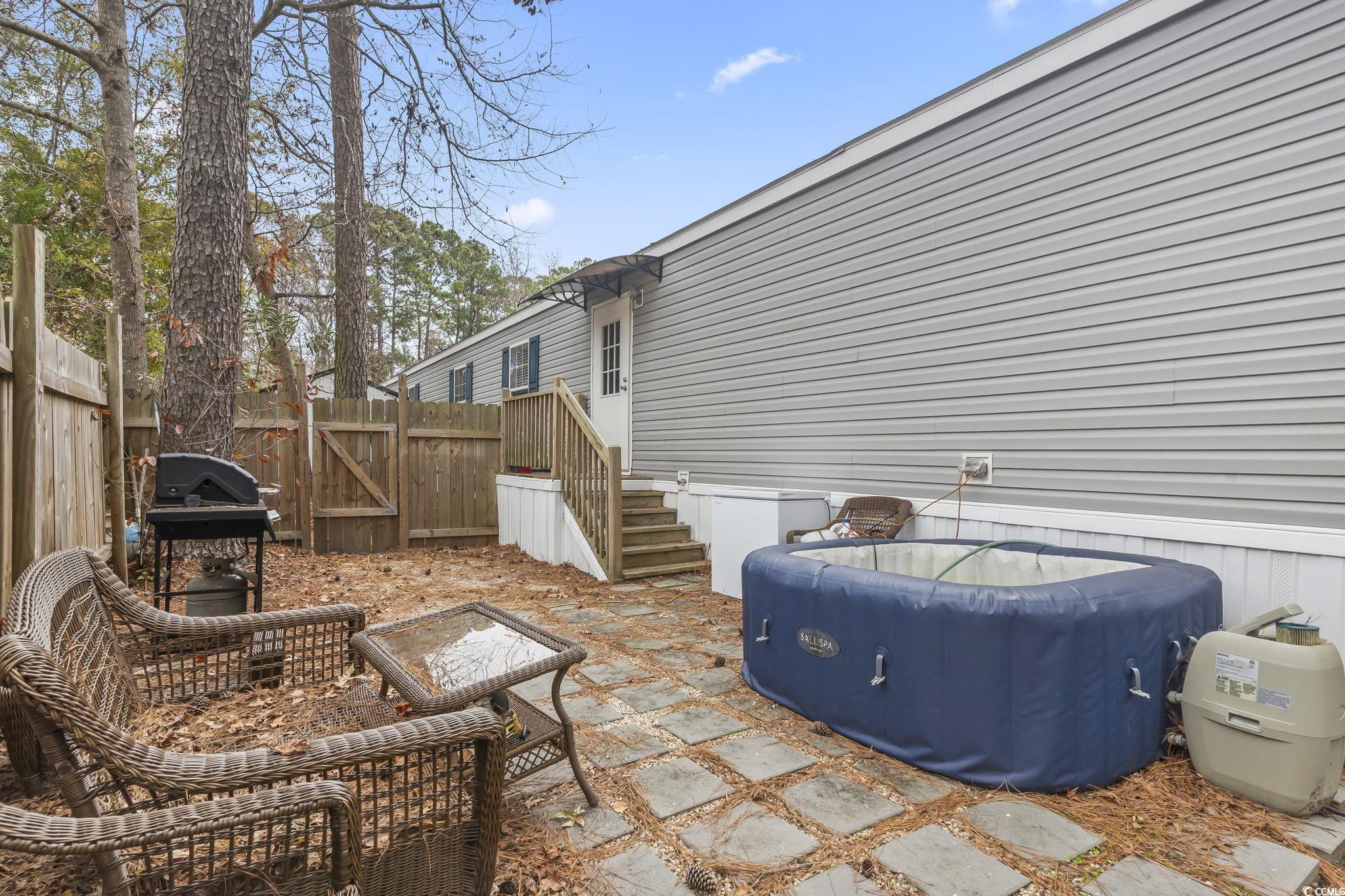 91 Offshore Drive Murrells Inlet, SC 29576 - Photo 20 of 24 Fenced backyard featuring a gate, a patio area, and grilling area
