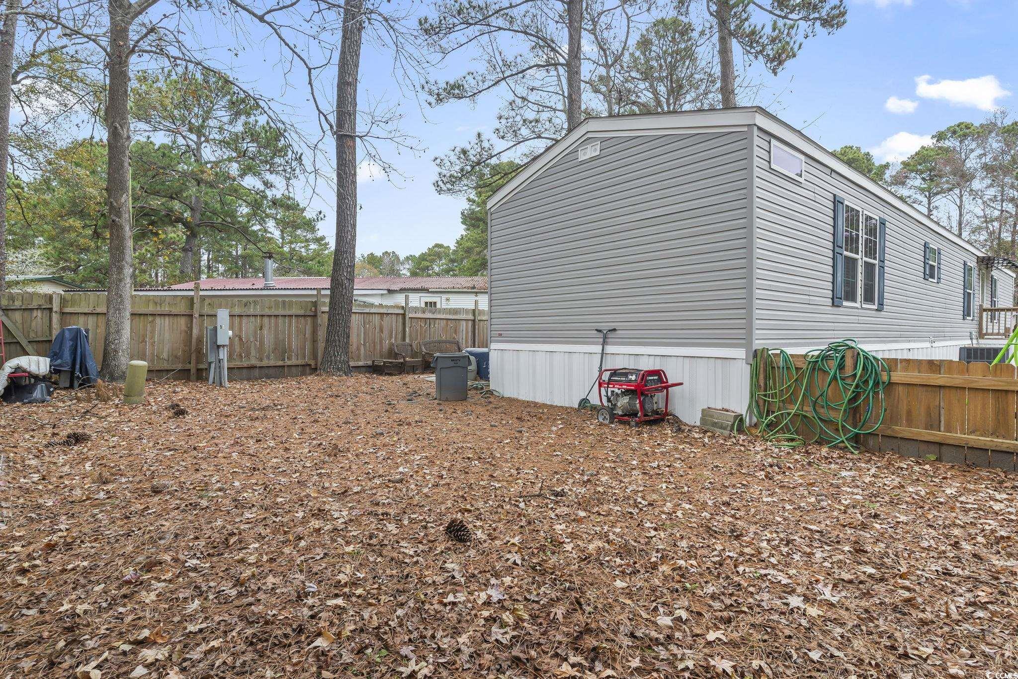 91 Offshore Drive Murrells Inlet, SC 29576 - Photo 24 of 24 View of home's exterior featuring a fenced backyard