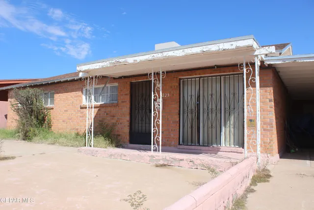 a view of a house with a wooden fence