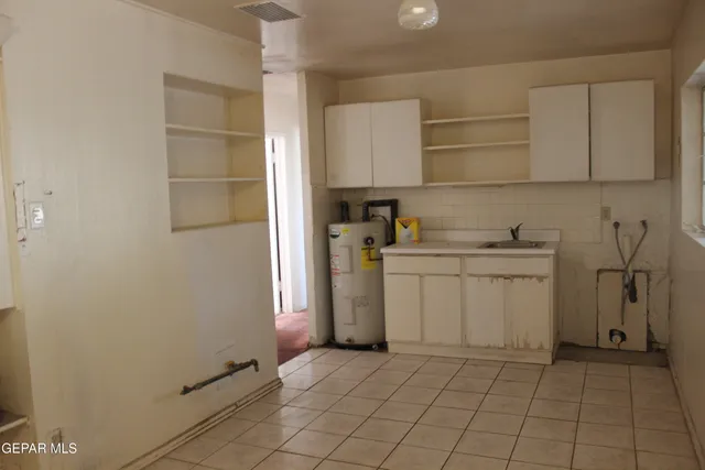 a utility room with cabinets washer and dryer