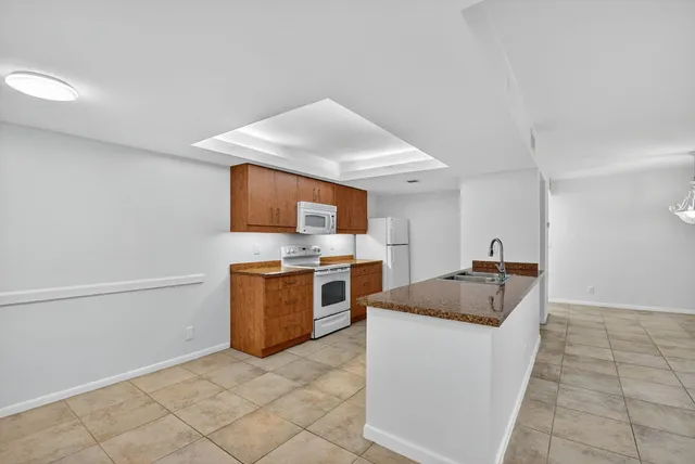 a view of a room with a ceiling fan and entryway