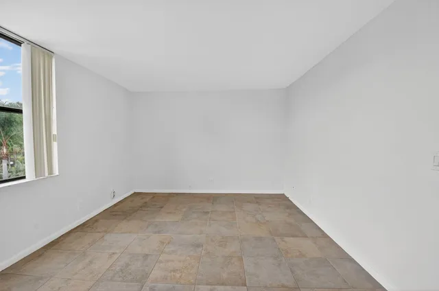 an aerial view of a house with a garden and lake view