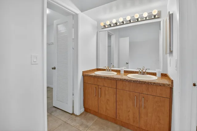 an aerial view of a house with a garden and lake view