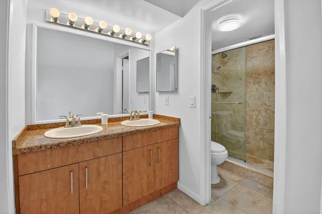 an aerial view of residential houses with outdoor space and street view