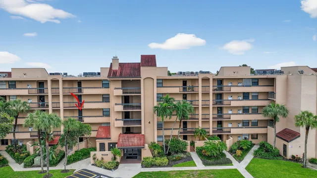 a view of a hallway with wooden floor and stairs