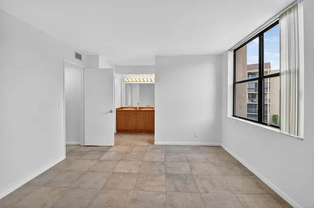 a front view of a building with a garden