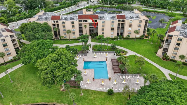 a front view of a house with a yard and potted plants
