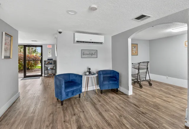 a view of a livingroom with workspace and a window