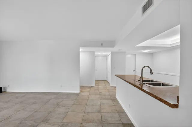 an empty room with sliding glass door and mountain view