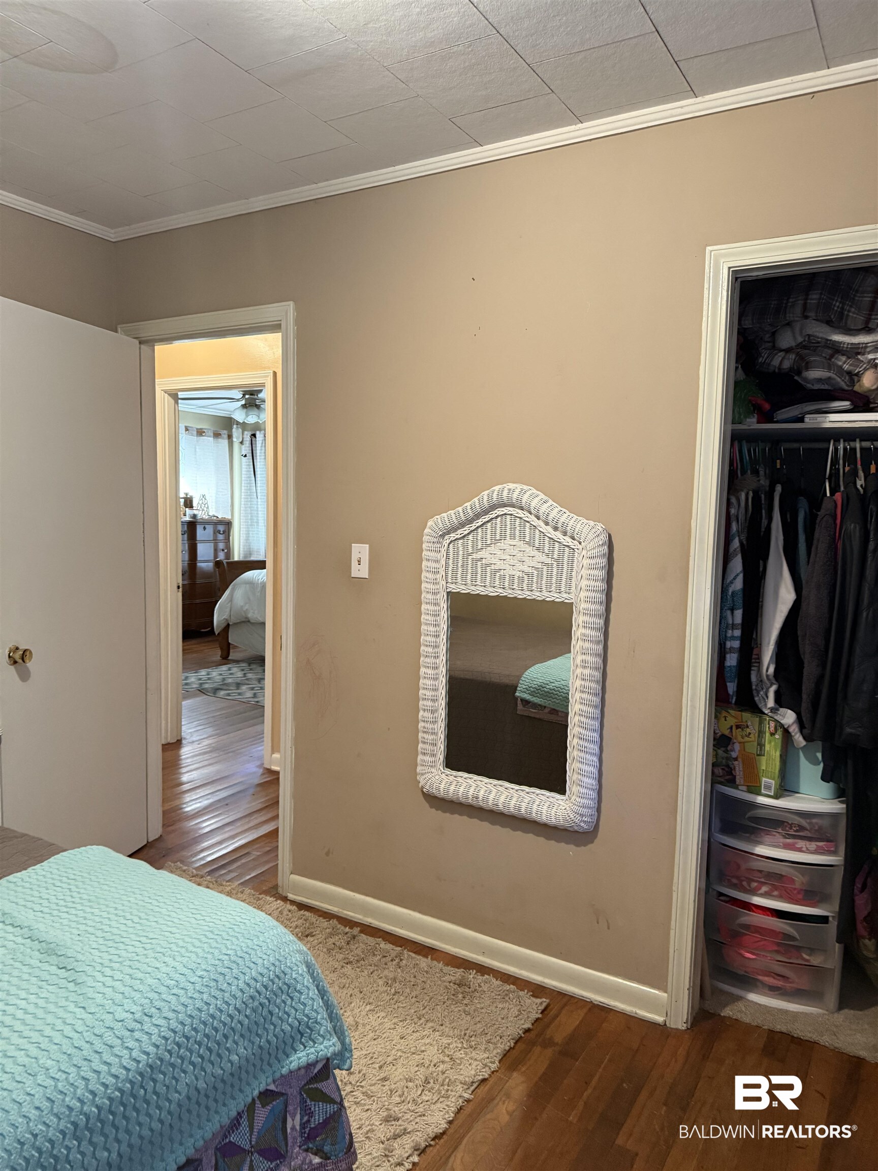 22173 1st Street Silverhill, AL 36576 - Photo 12 of 16 Bedroom with ornamental molding, dark wood-style flooring, and a closet