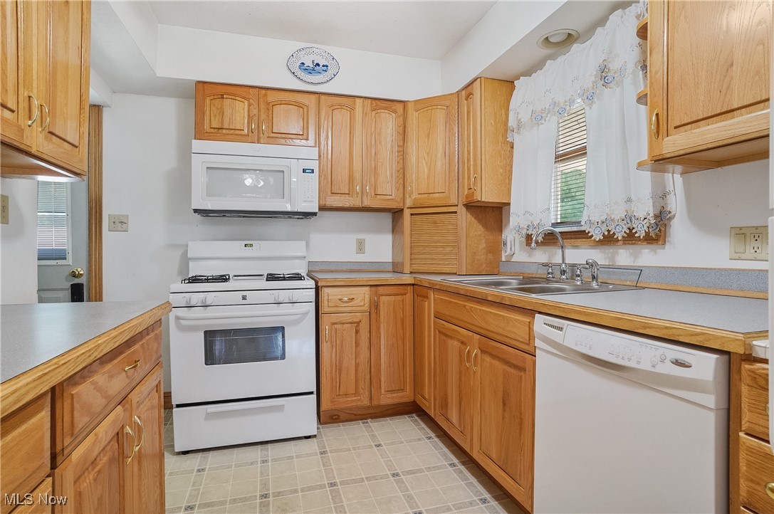 2809 McElwain Road Akron, OH 44312 - Photo 21 of 38 Kitchen featuring white appliances and light countertops