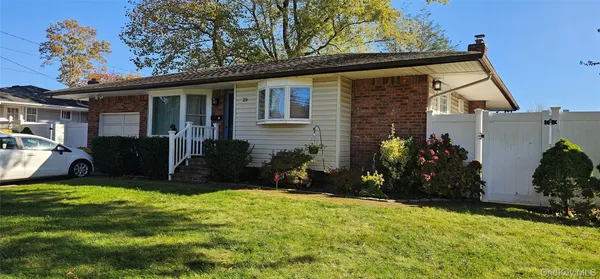 a view of a house with yard and sitting area