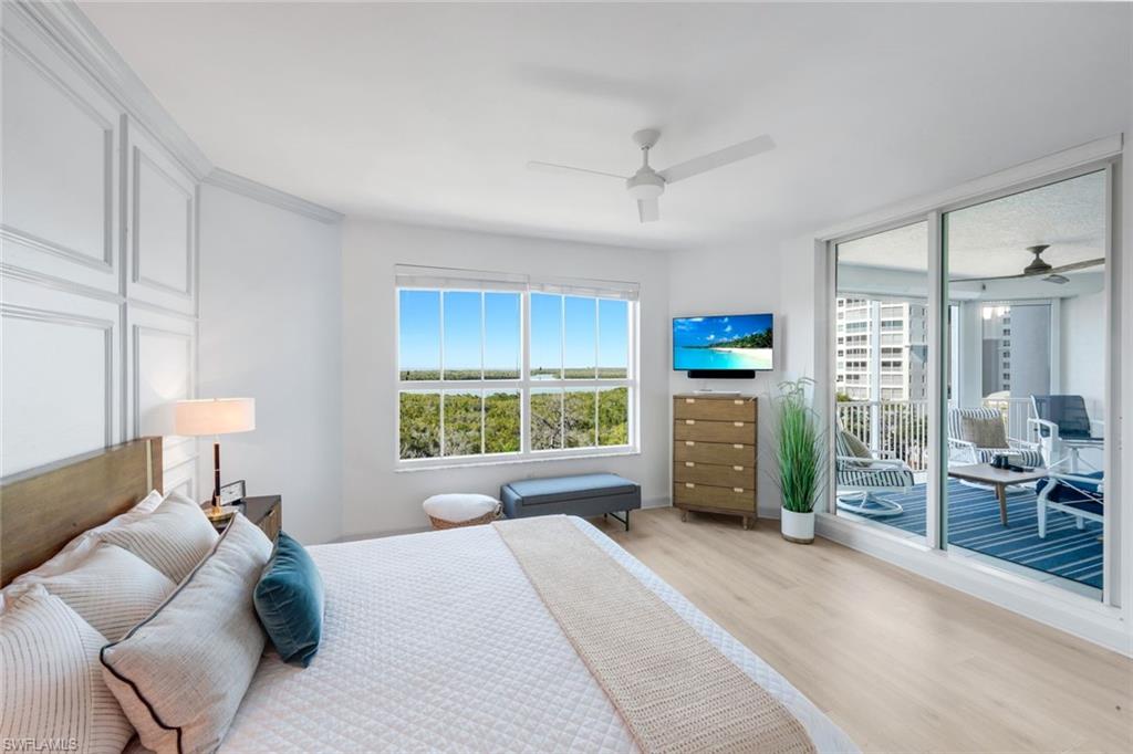 325 Dunes Boulevard, Unit 604 Naples, FL 34110 - Photo 16 of 41 a bedroom with a bed a window and a couch