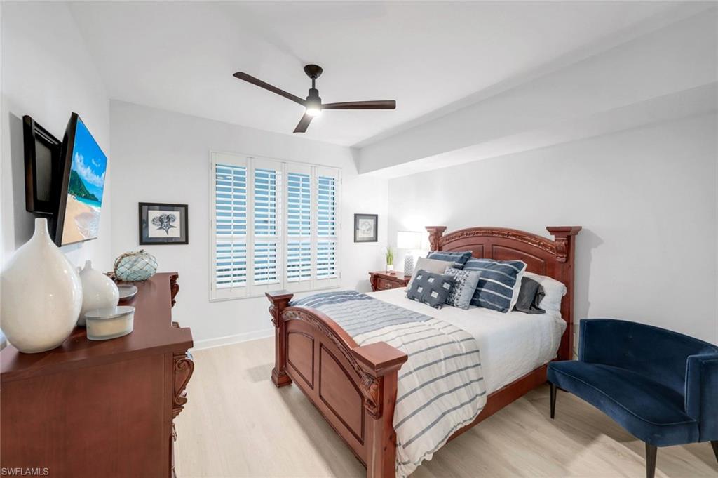 325 Dunes Boulevard, Unit 604 Naples, FL 34110 - Photo 18 of 41 a bedroom with a bed and wooden floor