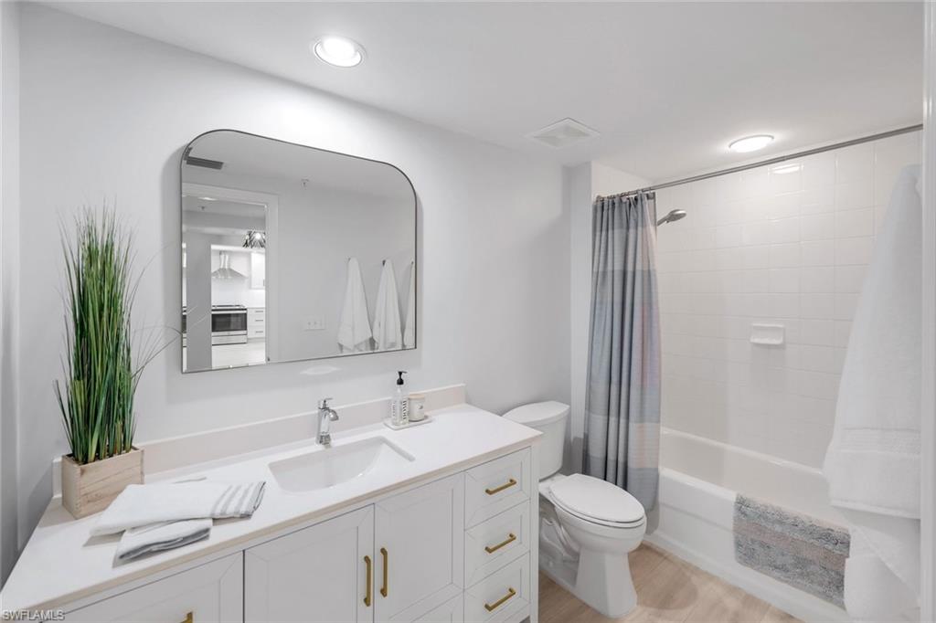 325 Dunes Boulevard, Unit 604 Naples, FL 34110 - Photo 19 of 41 a bathroom with a sink a toilet and shower