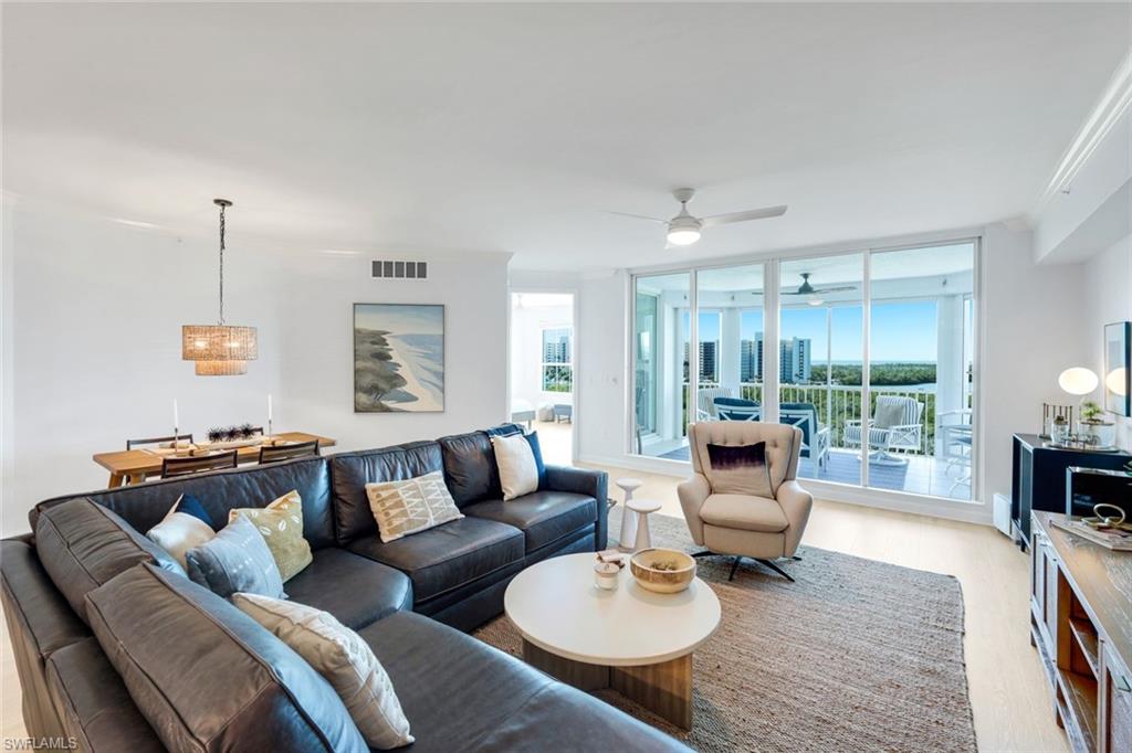 325 Dunes Boulevard, Unit 604 Naples, FL 34110 - Photo 2 of 41 a living room with furniture and a wooden floor
