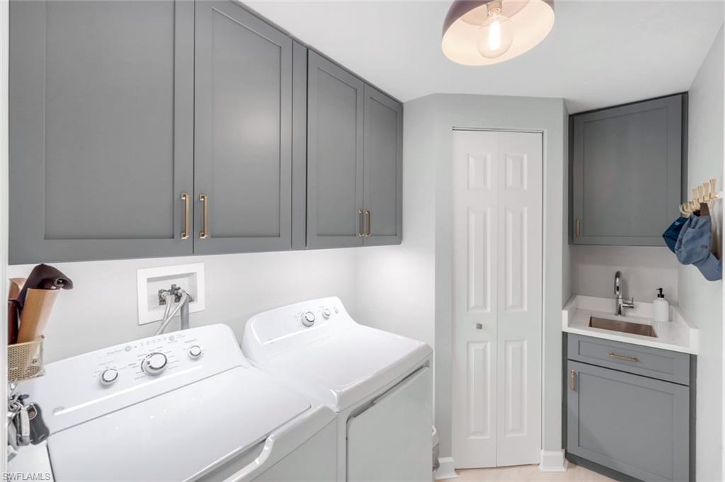 325 Dunes Boulevard, Unit 604 Naples, FL 34110 - Photo 21 of 41 a utility room with dryer and washer