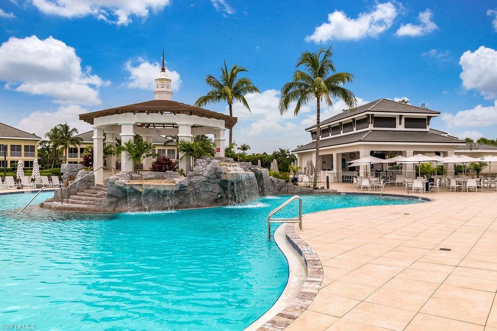 325 Dunes Boulevard, Unit 604 Naples, FL 34110 - Photo 31 of 41 a front view of house with yard and swimming pool