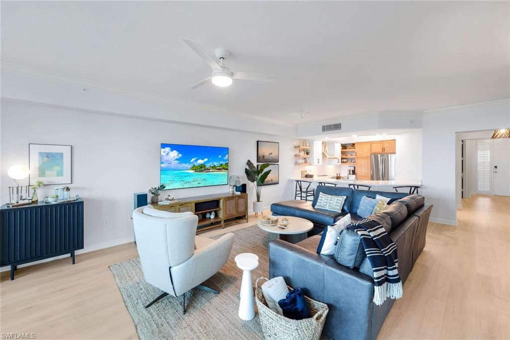 325 Dunes Boulevard, Unit 604 Naples, FL 34110 - Photo 4 of 41 a living room with furniture and a flat screen tv