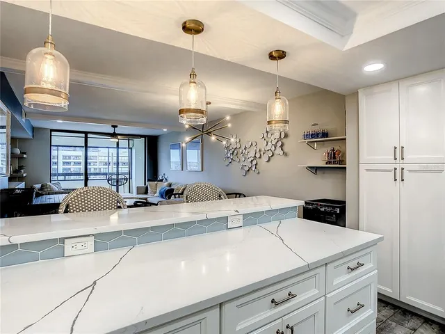 a kitchen with a white cabinets and chairs