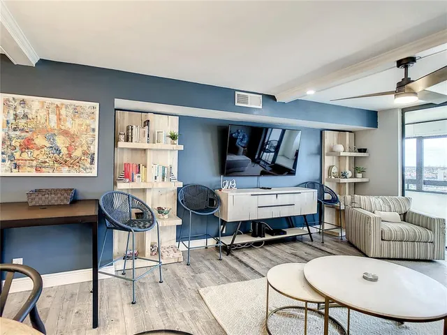 a bedroom with furniture and a floor to ceiling window