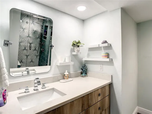 a bathroom with a shower and a glass door