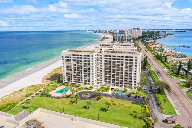a view of a balcony with a floor to ceiling window next to a yard