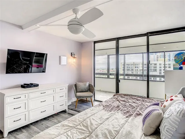 a bedroom with a large bed and a large window