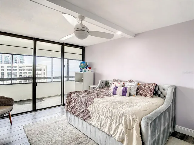 a bedroom with a bed and a flat screen tv in it