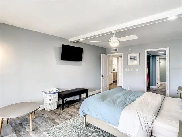 a bedroom with a large bed and a window