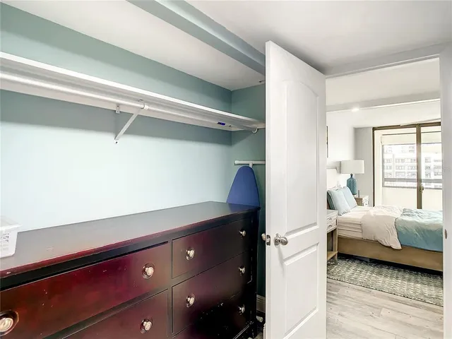 a view of walk in closet with clothes