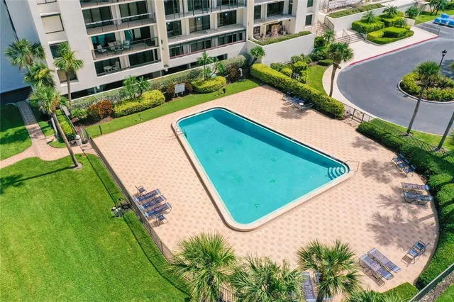 a view of a swimming pool with a yard