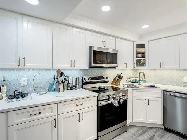 a kitchen with a sink and cabinets