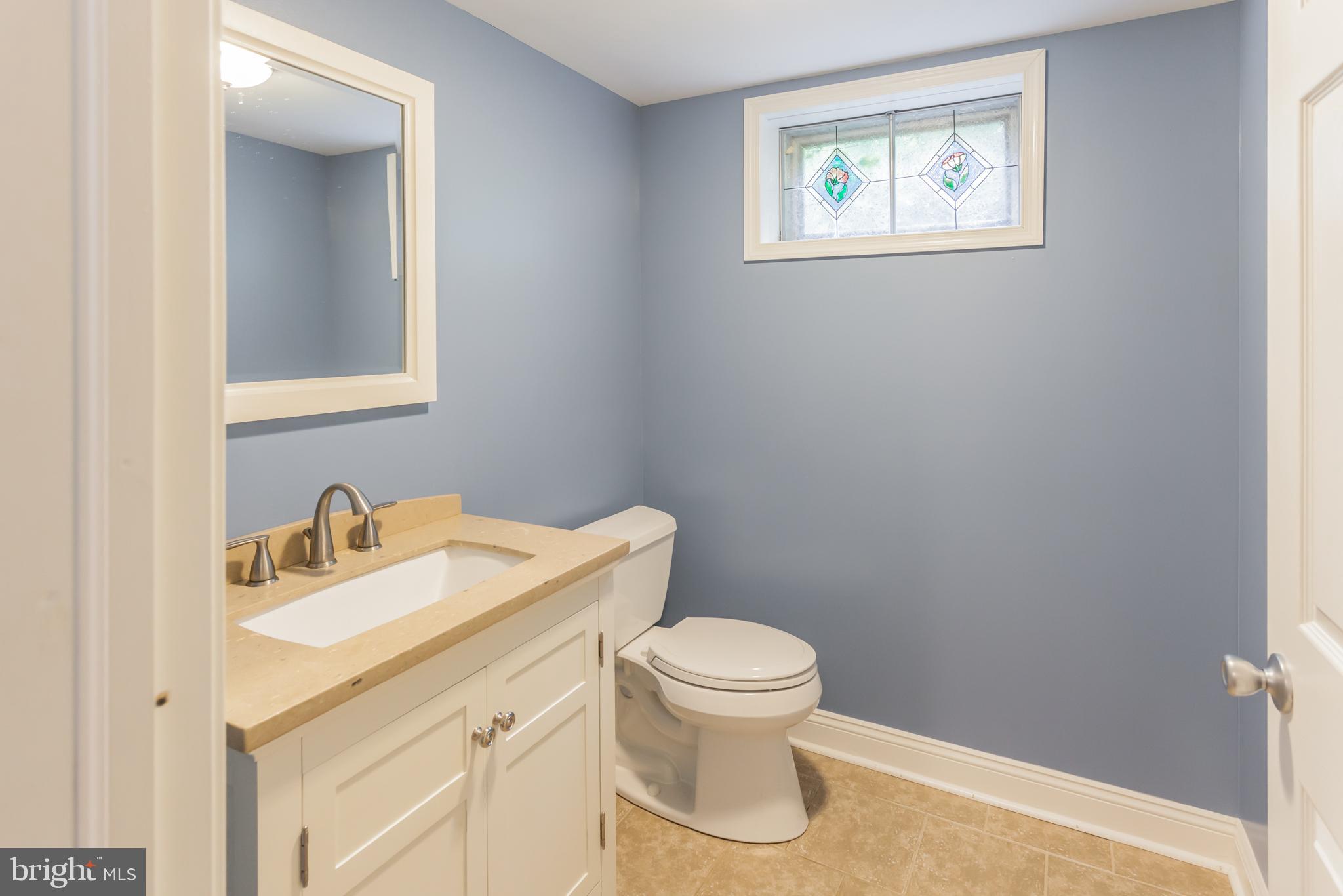 655 Chambers Rock Road Landenberg, PA 19350 - Photo 18 of 42 a bathroom with a toilet sink vanity and mirror