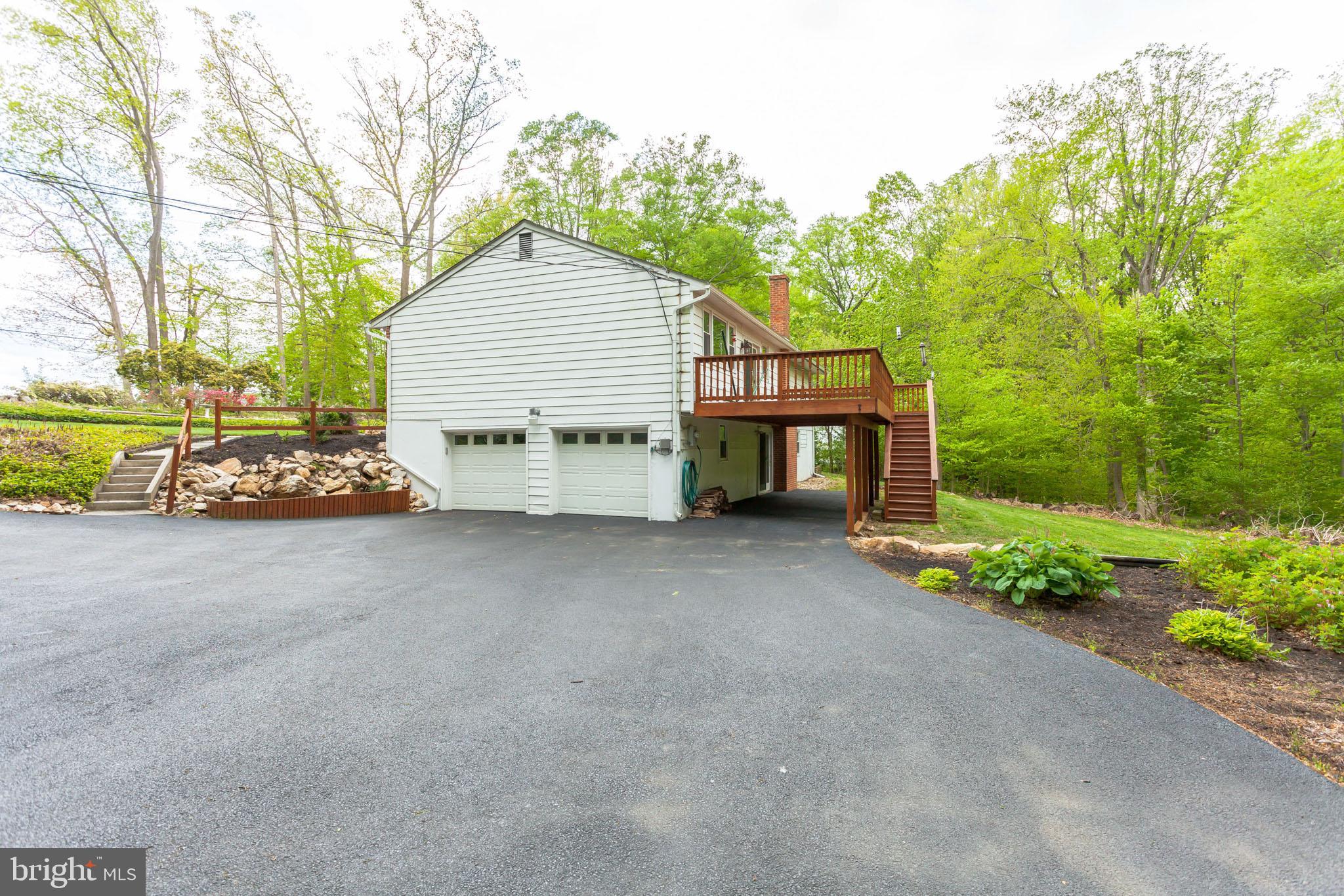 655 Chambers Rock Road Landenberg, PA 19350 - Photo 5 of 42 a view of a house with a yard and garage