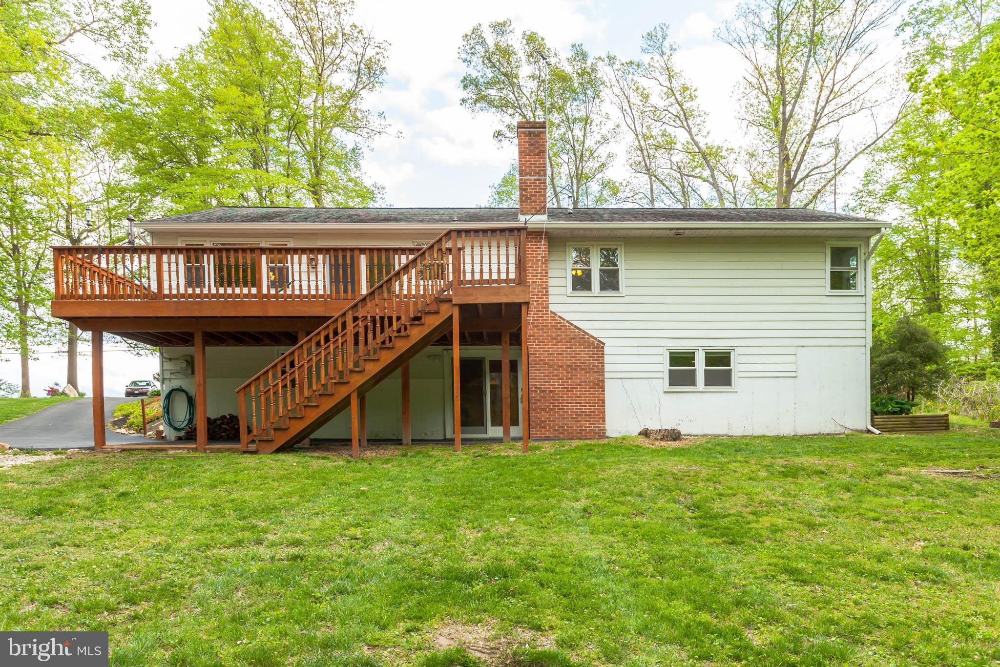 655 Chambers Rock Road Landenberg, PA 19350 - Photo 42 of 42 a view of a house with a yard and a wooden deck