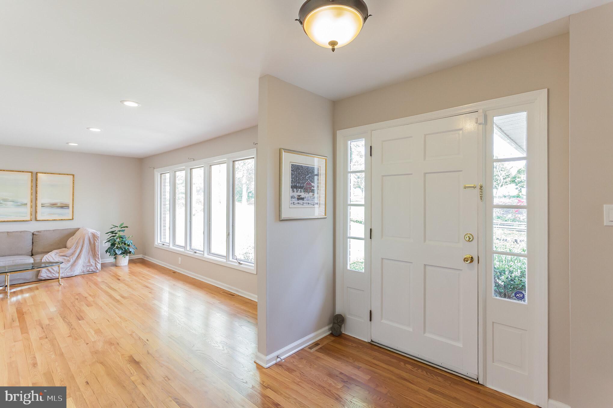 655 Chambers Rock Road Landenberg, PA 19350 - Photo 6 of 42 an empty room with wooden floor and windows