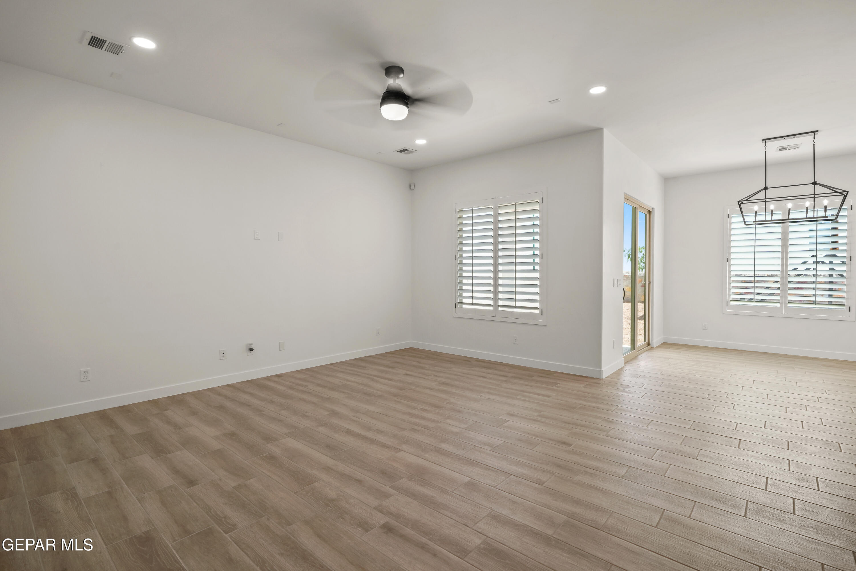 15221 Expectation El Paso, TX 79938 - Photo 11 of 38 an empty room with wooden floor and windows