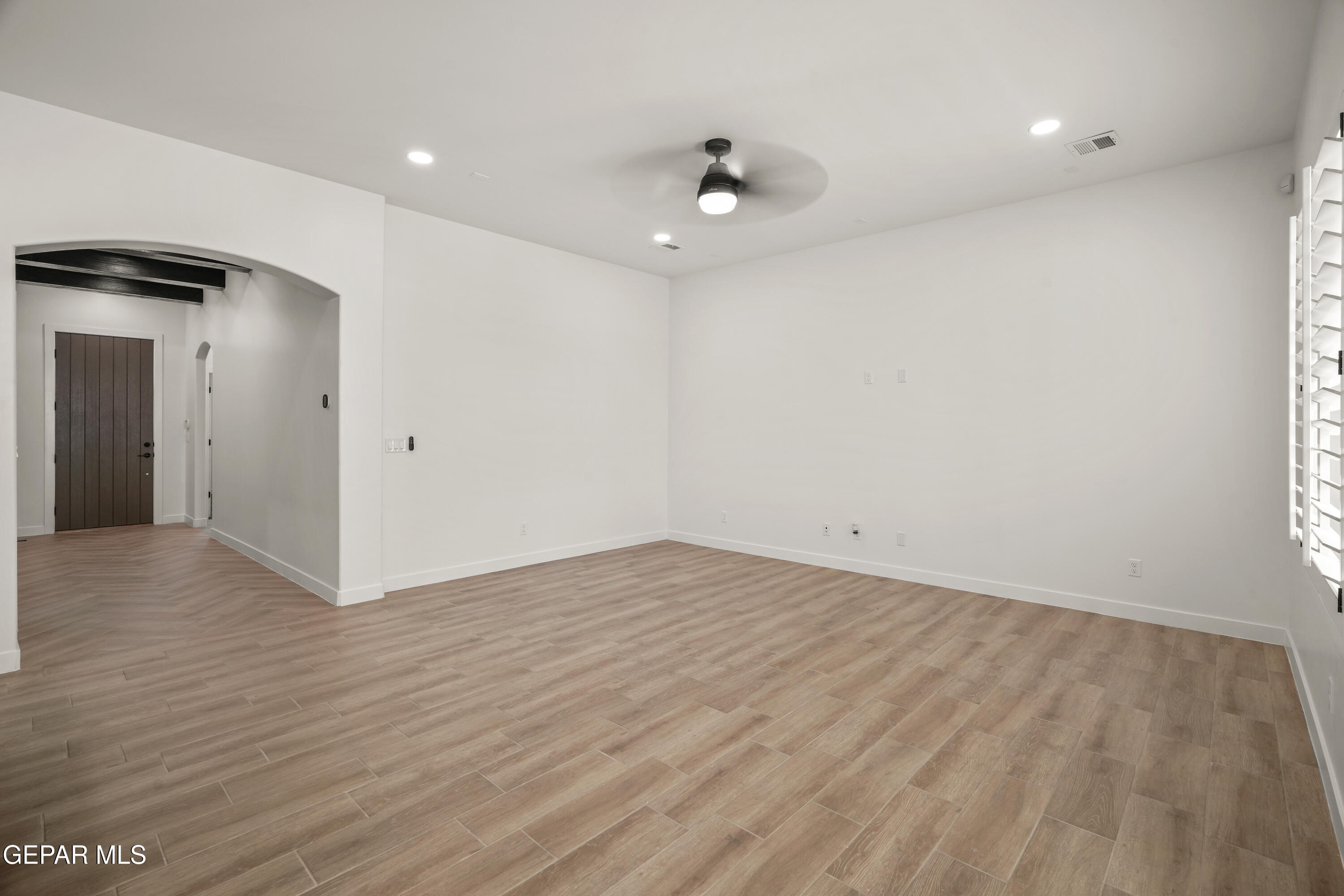 15221 Expectation El Paso, TX 79938 - Photo 13 of 38 a view of an empty room with wooden floor and a ceiling fan